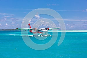 Male, Ari Atoll, Maldives - December 16. 2016: Seaplane of Trans Maldivian Airways landing in blue sea