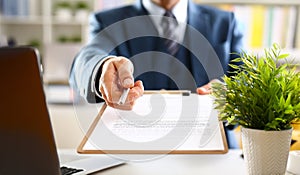 Male arm in suit offer contract form on clipboard