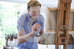 Male Artist Painting In Studio