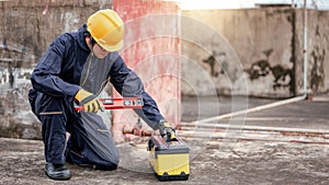 Male Asian mechanic preparing work tool at site