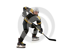 Male athlete, hockey player in black uniform and helmet training, competing isolated on white background
