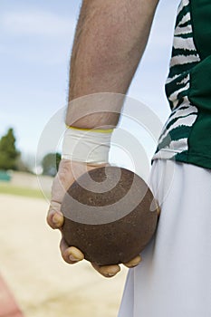 Male Athlete Holding Shot Put