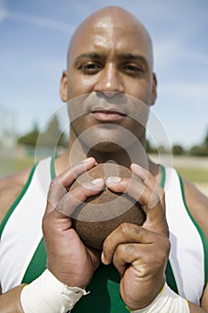 Male Athlete Holding Shot Put