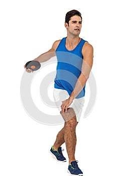 Male athlete playing discus throw on white background