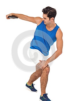 Male athlete playing discus throw on white background