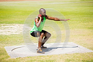 Male athlete preparing to throw shot put ball