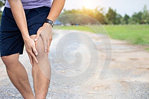 Male athlete runner knee injury and pain after jogging. Athlete man runner touching knee in painful