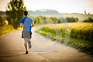 Male athlete/runner running on road