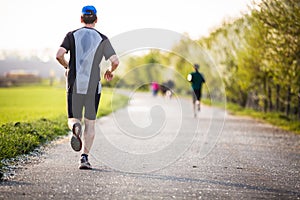 Male athlete/runner running on road