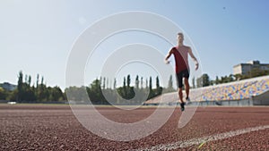 Male athlete running fast, gaining speed before finish, training endurance