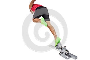 Male athlete running from starting blocks