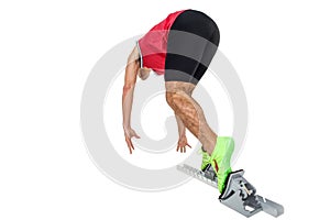 Male athlete running from starting blocks