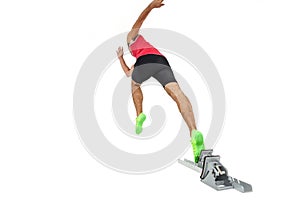 Male athlete running from starting blocks