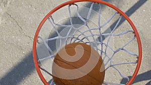 Male athlete shooting a ball through the basket, professional basketball player