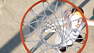 Male athlete shooting ball through basket, professional basketball player