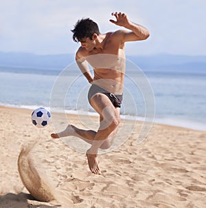 Male athlete, soccer and sand on beach, exercise and training for cardio sports. Bathing suit, football and athletic man