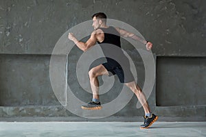 Male athlete sprinter running, exercising indoors