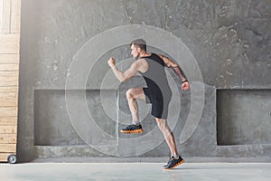 Male athlete sprinter running, exercising indoors