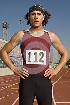 Male Athlete Standing On Racetrack