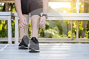 Male athlete tying shoe laces in minimalistic barefoot sneakers getting ready for training. Sport workout and healthy lifestyle