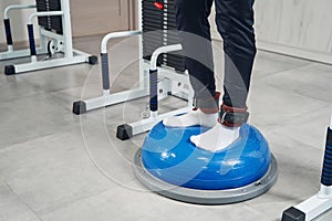 Male athlete working out on training device