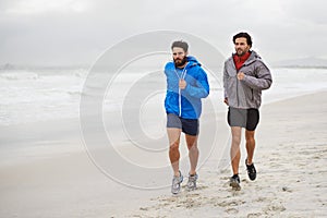 Male athletes, running and workout on beach, sand and fitness for wellness and gym wear on coast travel. Men, jog and