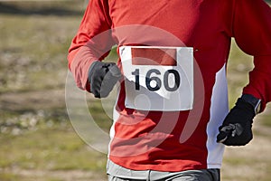 Male athletic country cross runner on a race. Outdoor circuit.