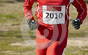 Male athletic runner on a cross country race. Outdoor circuit.