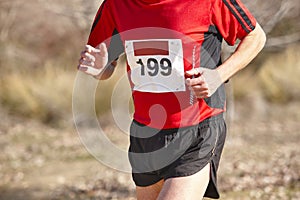 Male athletic runner on a cross country race. Outdoor circuit