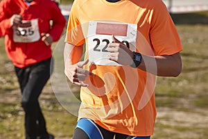 Male athletic runner on a cross country race. Outdoor circuit