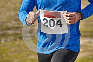 Male athletic runner on a cross country race. Outdoor circuit.