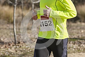 Male athletic runner on a cross country race. Outdoor circuit.