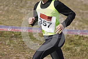 Male athletic runner on a cross country race. Outdoor circuit