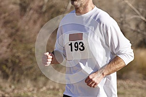 Male athletic runner on a cross country race. Outdoor circuit