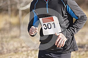 Male athletic runner on a cross country race. Outdoor circuit