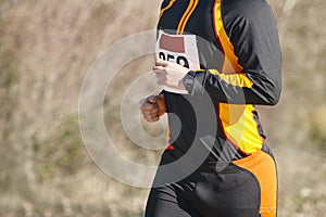 Male athletic runner on a cross country race. Outdoor circuit