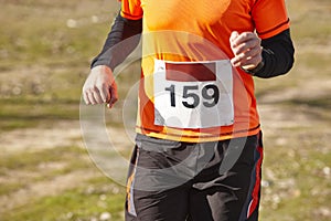 Male athletic runner on a cross country race. Outdoor circuit