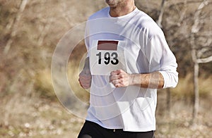 Male athletic runner on a cross country race. Outdoor circuit