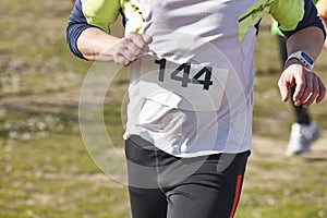 Male athletic runners on a cross country race. Outdoor circuit