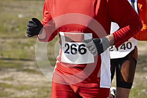 Male athletics runner on a cross country race. Outdoor circuit.