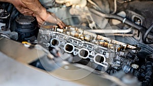 Male auto mechanic hand checking car engine part