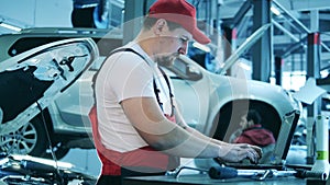 Male auto mechanic at work at an automobile repair shop