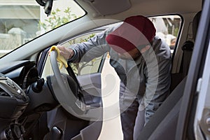 Auto service staff cleaning car interior