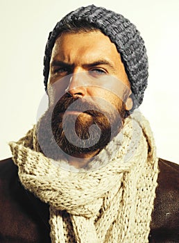 Male autumn-winter fashion. Fashionable handsome bearded man in gray hat and white scarf. Handsome man in demi-season