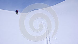 Male backcountry skier climbing a mountain on a beautiful winter day in the Alps near St. Moritz