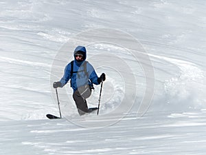 Male backcountry skier telemark skiing in the Alps in fresh powder photo