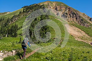 Backpacker on trail below summit