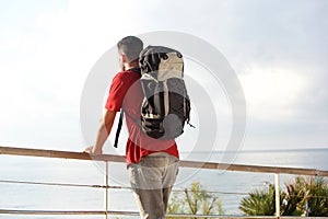 Male backpacker looking at the sea