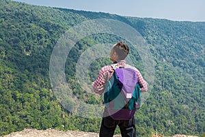 Male Backpacker Stand on cliff while Travel Trekking Trip over G