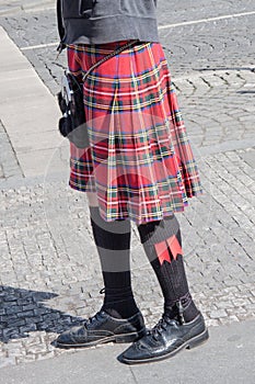 Male Bagpiper wearing Highland dress on the Street